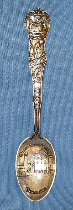 Souvenir Mining Spoon Calumet Hecla Mine Calumet MI.JPG - SOUVENIR MINING SPOON CALUMET & HECLA SHAFT NO 2 CALUMET MICHIGAN - Sterling souvenir mining spoon, 5 1/2 in. long, embossed mining scene in bowl, marked CALUMET & HECLA SHAFT NO. 2, CALUMET, MICH., handle with MI state seal at top and miner with pick, marked MICHIGAN, reverse shows designs of teepee and canoe with Sterling stamping and makers mark, ex-John Rascona collection [In 1864, Edwin J. Hulbert discovered a copper-bearing section of what became known as the Calumet Conglomerate in Houghton County, Michigan. Hulbert formed the Calumet Company in 1865, with Boston investors. The company spun off the Hecla Company the following year, and assigned shares in the new company to Calumet shareholders.  Hulbert was a major shareholder in both companies, and was in charge of mine operations. But despite the rich ore, Hulbert did not have the practical knowledge to dig out the ore, crush it, and concentrate it. Frustrated with Hulbert’s lack of success, the company sent Alexander Agassiz to run the mine.  Under Agassiz’ expert management, the Hecla Company paid its first dividend in 1868, and the Calumet Company began paying dividends in 1869. The two companies merged in May 1871 to form the Calumet & Hecla Mining Company, with Quincy Adams Shaw as its first president. In August of that year, Shaw retired to the board of directors and Agassiz became president, a position he held until his death. The town of Red Jacket (now named Calumet) formed next to the mine.  Calumet and Hecla built itself into a copper mining colossus. From 1868 through 1886, it was the leading copper producer in the United States, and from 1869 through 1876, the leading copper producer in the world.  From 1871 through 1880, Calumet and Hecla turned out more than half the copper produced in the United States. In each year save one between 1870 and 1901, Calumet and Hecla made most of the copper produced in the Michigan copper district.  By 1901 the underground mining complex had 16 shafts. Annual copper production from the mines peaked in 1906 at 100 million pounds then declined to 67 million pounds by 1912 in response to lower prices.  Copper prices fell drastically after WW I and the company shut down mining on the Calumet conglomerate in April 1921.  Copper production rebounded in 1922, and rose steadily through the 1920s. Calumet and Hecla grew in the 1920s by buying and merging with neighboring copper mines. In 1923, Calumet and Hecla merged with the Ahmeek, Allouez, and Centennial mining companies. The combined entity was renamed the Calumet and Hecla Consolidated Copper Company. The merged company essentially controlled all the operating copper mines north of Hancock, Michigan.  During the Great Depression, copper prices dropped, and as a result most copper mines in the Copper Country closed, including Calumet and Hecla. Following WW II, the company resumed operations but was unable to produce enough copper for its internal uses. Universal Oil Products bought Calumet and Hecla in April 1968. The company shut down the dewatering pumps in 1970 and the mines have remained idle ever since, and most are permanently capped.  Today, many Calumet and Hecla company mines and buildings are part of Keweenaw National Historical Park.]